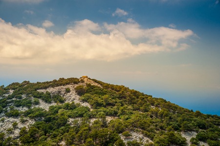 Beautiful landscape with a little house in rocky mountains on the western part of Mallorca island, Spain. Tramuntana mountains with forest. Tourist trekking destination in Spain. Travel timelapse of a landmark.の写真素材