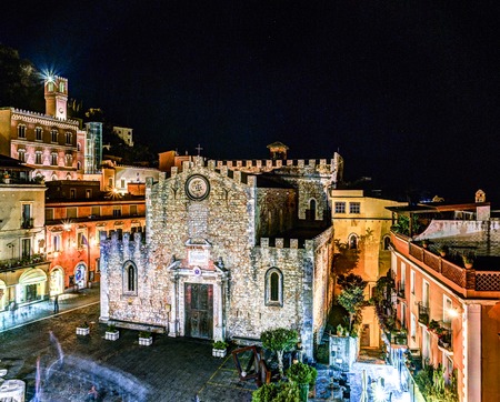 The Duomo in most popular sicilian resort Taormina. Night aerial view. Townscape of Taormina with cathedral, square and the hill with other buildings.の写真素材