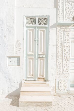 Traditional old painted door in a historical district or medina, Tunisia.の写真素材