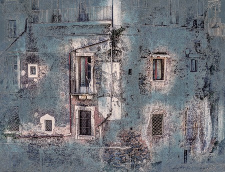 red vintage old brick wall with windows and green ivyの写真素材