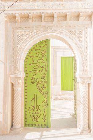 Traditional old painted door in a historical district or medina, Tunisia.の写真素材