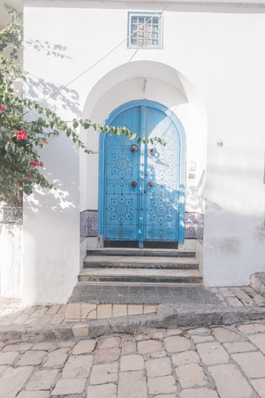 Traditional old painted door in a historical district or medina, Tunisia.の写真素材