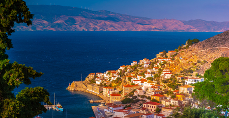 Panoramic view of the port of Hydra town, Hydra island, Attica, Greece. Photo taken from Kiafa, the old part of the town, In the background the coast of Argolis, Peloponnese.の写真素材