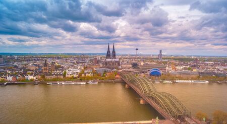 Aerial view of the cathedral in Cologne and Hohenzollern bridge over Rhein, Germany. Pictoresque view on the famous landmarks of Cologne in Germany.の素材 [FY310131534591]