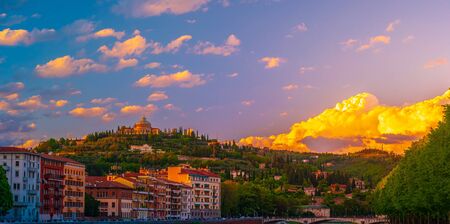 Verona, Italy. A scenic panoramic view of the river of Adige and its embankments on a cloudy and bright dayの写真素材