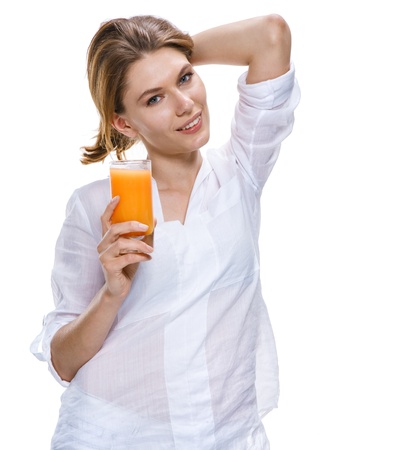Young beautiful woman with glass of orange juice isolated on white backgroundの写真素材