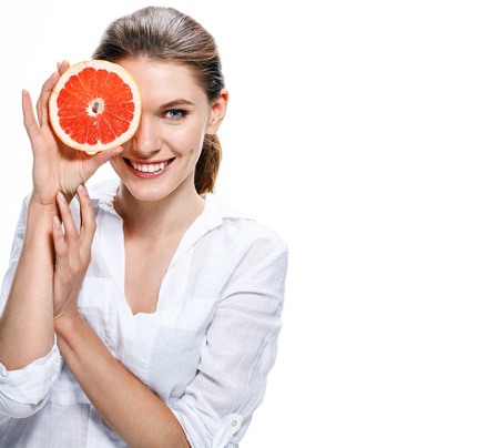 brunette european woman with orange slice - isolated on white backgroundの写真素材