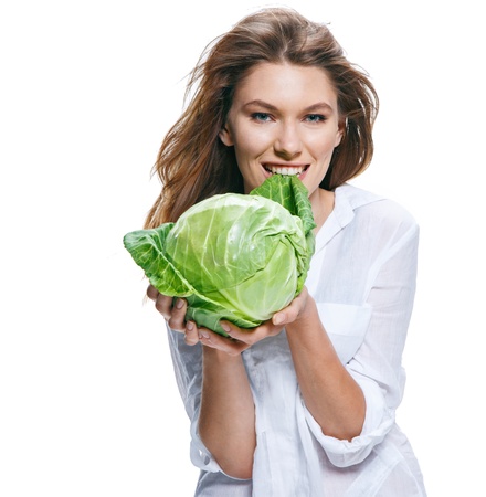 Young beautiful woman with cabbagehead in hand isolated on white backgroundの写真素材