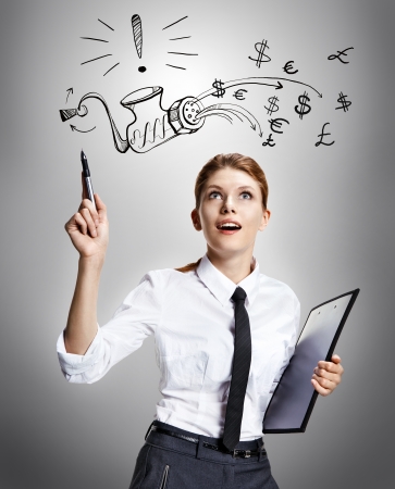 All exceptionally clear - studio shoot of beautiful attractive business woman wearing a white shirt with a tie and a folder in her hand reading the signs - on grey backgroundの写真素材