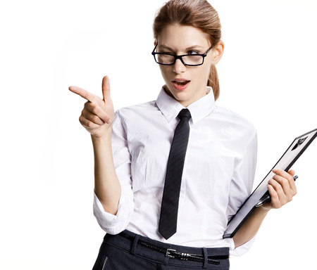 Beautiful girl is gesturing - portrait of sexy young business woman pointing over white backgroundの写真素材