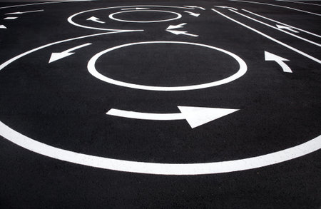 Roundabout markings signs - photography of road markings and traffic symbol on surface road