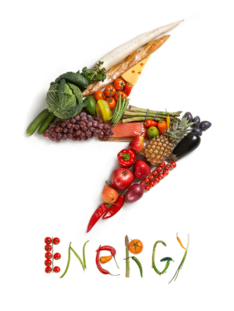 Energy diet - healthy food symbol represented by foods in the shape of flash to show the health concept of eating well with fruits and vegetablesの写真素材
