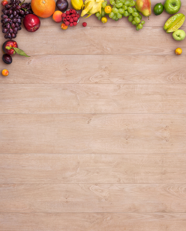 Healthy eating background - studio photography of different fruits and vegetables on wooden tableの写真素材