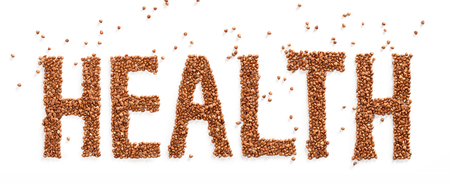 Word HEALTH composed of premium buckwheat groats on white backgroundの写真素材