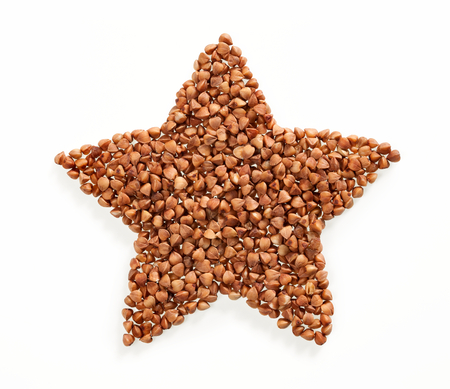 Star shape made of premium buckwheat groats on white backgroundの写真素材