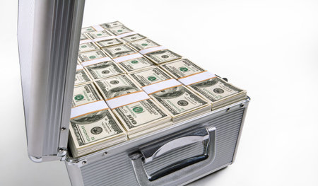 studio photography of silver case with hundred dollar bills on a white background