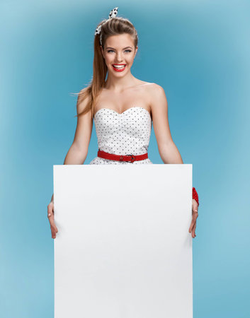 photo set of young American pin-up model on blue background with space for textの写真素材