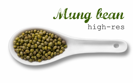Mung beans in a wooden spoon / high resolution product photography of seed in white porcelain spoon over white background with place for your textの写真素材