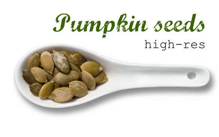 Peeled pumpkin seeds in white porcelain spoon / high resolution product photography of seed in white porcelain spoon over white background with place for your textの写真素材