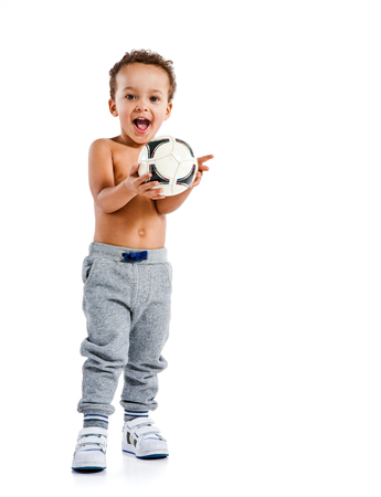Mixed race boy holding soccer ball  photo set of Hispanic kid wearing sports clothes over white backgroundの写真素材