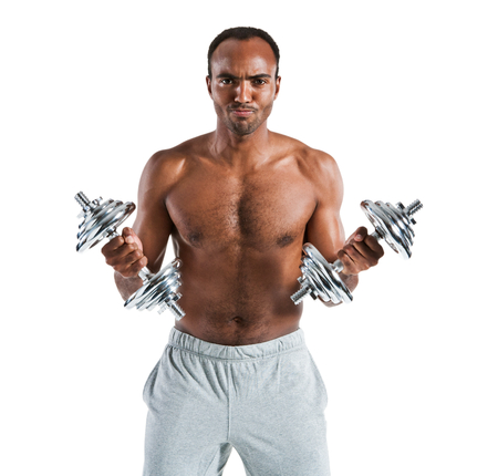 Athletic young man doing a fitness workout with weights  photo set of sporty muscular Hispanic shirtless fitness guy wearing sports clothes working out with dumbbell over white backgroundの写真素材