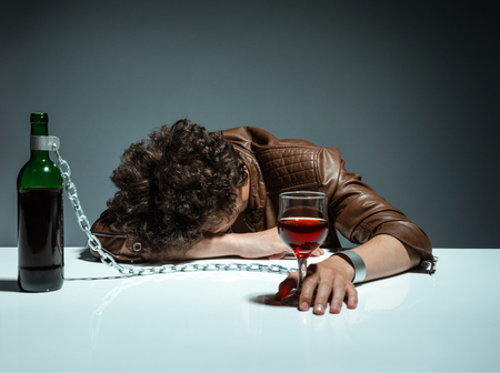 Young man passed out from alcohol  photo of youth addicted to alcohol, alcoholism concept, social problem