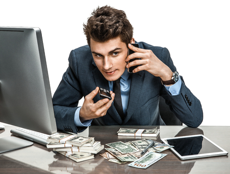 Successful businessman going to make a call by cell phone  modern businessman at the workplaceの写真素材