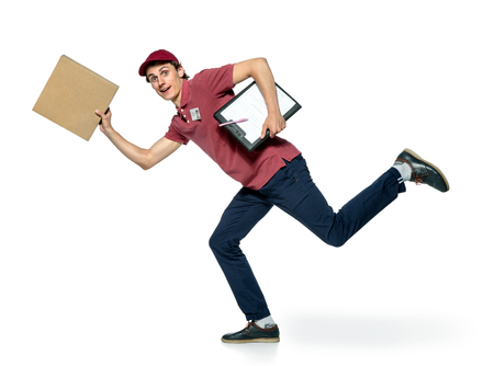 Male courier company worker delivering a package. isolated on white backgroundの写真素材