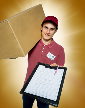 Smiling delivery man holding a paper box and requests to subscribe courier on golden background.の写真素材