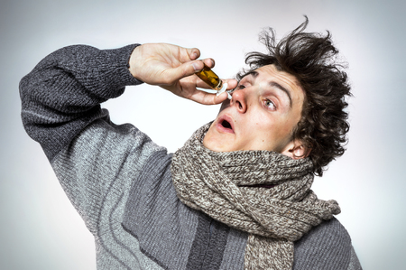 Man Using Nose Spray Medication or drugs abuse, healthcare conceptの写真素材