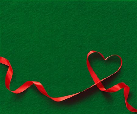 Red Ribbon Heart on green backgroundの写真素材