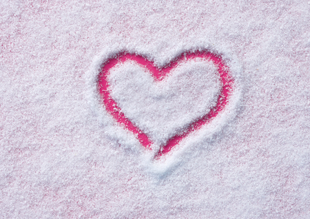 Snow background inside a pink heart.の写真素材