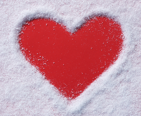 Snow background inside a red heart.の写真素材