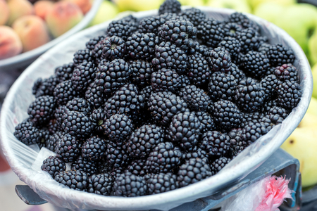 Fresh Blackberry in bowl on the table, top view, close-up. Selective focus.の写真素材