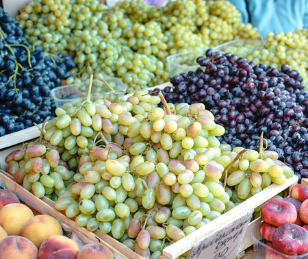 Grape in a rustic wooden basket photography of grapes, grapes on market stall, close-up. Selective focus.の写真素材