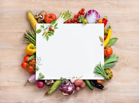 Healthy food background and Copy space, studio photography of open blank ring bound notebook surrounded by a fresh vegetables and pencil on old wooden tableの写真素材