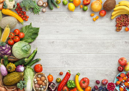 Healthy food background. Studio photo of different fruits and vegetables on white wooden table. High resolution product.