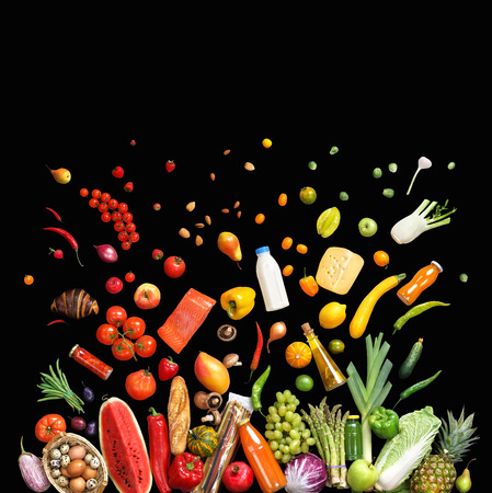 Deluxe food background. Studio photo of different fruits and vegetables isolated on black background, top view. High resolution productの写真素材