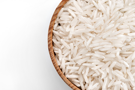 Rice in wooden bowl on white background. Close up, top view, high resolution product.の写真素材