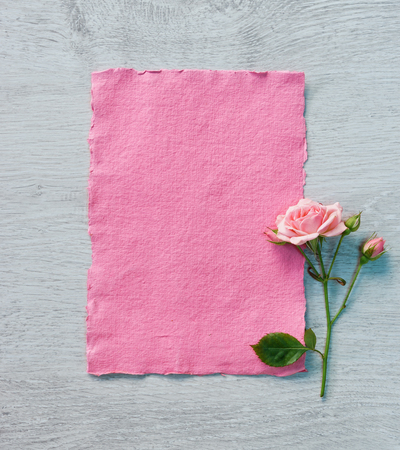 Valentine pink card with rose on wooden background. Copy space for your text. Valentines Day conceptの写真素材
