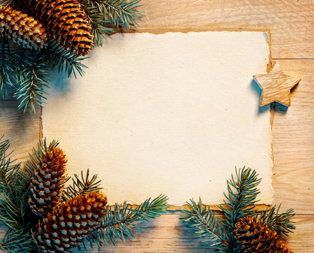 Christmas letter with fir branches,pinecones on wooden board. Merry Christmas and Happy New Year!! Top view.の写真素材