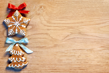 Two Gingerbread cookies on wooden table. Close up, top view. Merry Christmas and Happy New Year!の写真素材