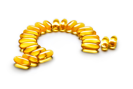 Omega-3 capsules - letter shape, isolated on white background. Close up, copy space, high resolution product. Health care conceptの写真素材