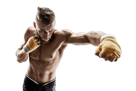 Muscular man throwing a fierce and powerful punch. Photo of sporty man isolated on white background. Strength and motivationの写真素材