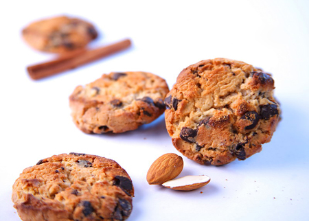 Chocolate chip cookies with almonds and cinnamon on white background. Close upの写真素材