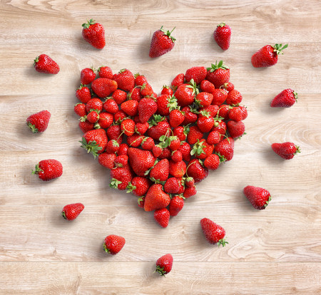 Heart symbol from strawberry on wooden background. Fruits diet concept. Top view. High resolution productの写真素材