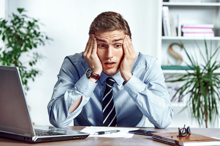 Frustrated businessman dissatisfied his earnings. Photo of young man working in the office. Business...