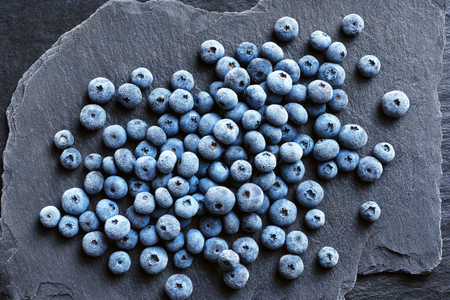 Frozen blueberry on black slate. Close up. Top view. High resolution product.の写真素材