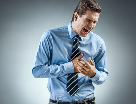 Office manager holding hands on painful chest. Medical concept. Heart attack.の写真素材
