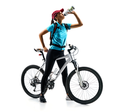 Cyclist in blue t-shirt with bicycle drinking a water in silhouette on white background. Sport and healthy lifestyleの写真素材